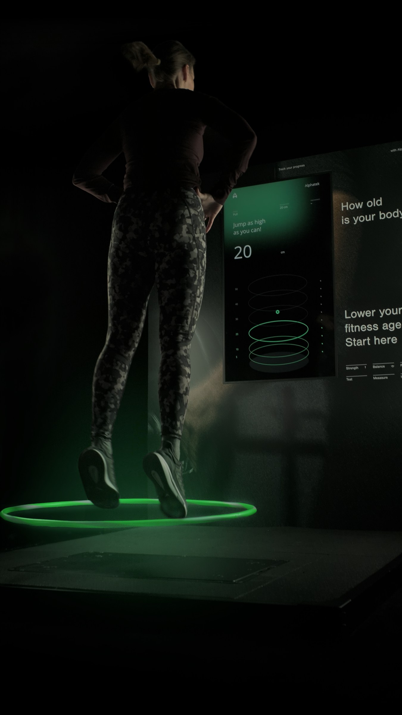 An adult completes a guided jump activity on Alphatek.